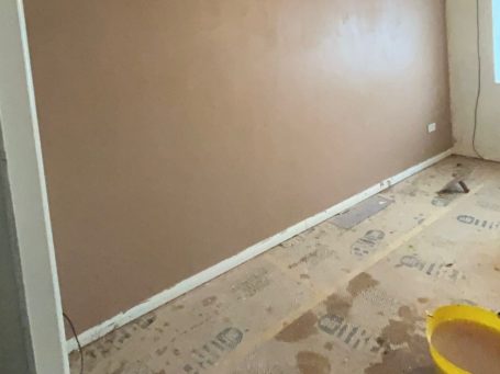 A partially finished room with fresh plastered wall