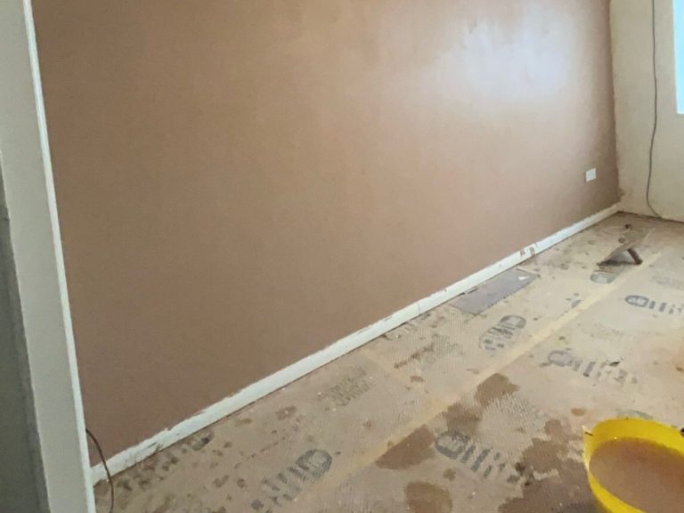A partially finished room with fresh plastered wall